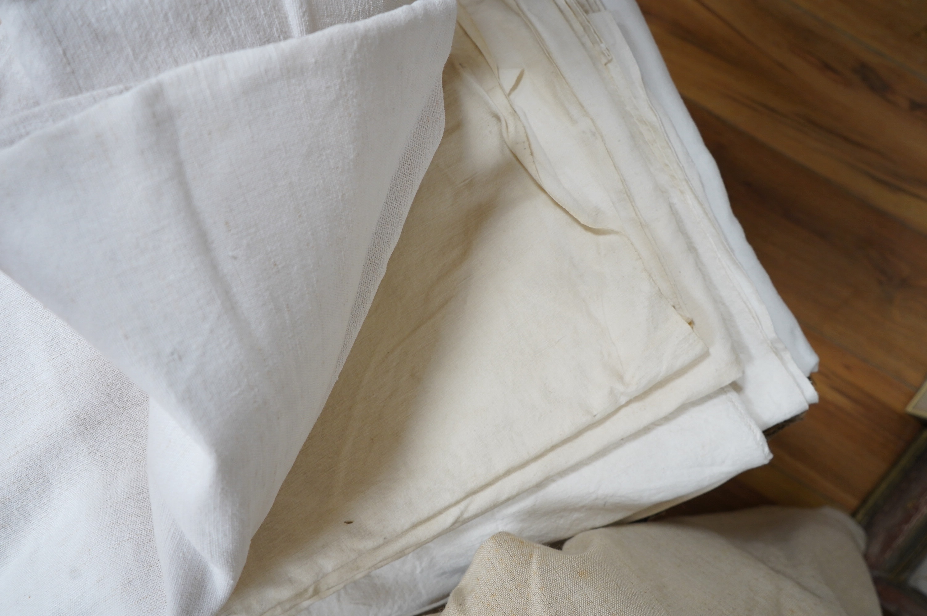 Sixteen French provincial coarse linen sheets, together with a similar roll of approximately 10 meters. Condition - variable